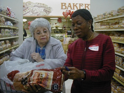 Gladys Beechner and Sherma Brisseau review a nutrition label as part of the Prince George's County Health Department Healthy Guided Supermarket Tour. Photo by Hallie C. Falquet.