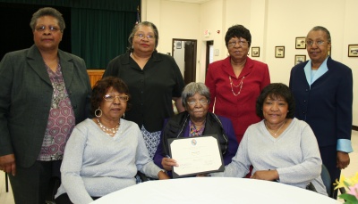 Hazel Gutrick of Nanjemoy, surrounded by her six daughters, celebrates 100 years of life. (Standing from left: Geraldine Ward, Virmia Cobey, Pearl Smith, and Annie Warren; Seated from left: Betty Ross, Hazel Gutrick, and Shirley Lewis) (Photo: George Clarkson, Press Secretary, Charles County Government)