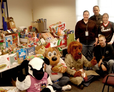 Lt. Billy Caywood — commander of the Community Services Division — Teen Court Coordinator Sarah Vaughan, Chick-fil-A Marketing Director Mindi Roberts and Community Policing Officer Jeremy Timko prepare to deliver food to local food pantries. Joining them are the Chick-fil-A Cow, played by Faith Hook, Scruff, played by Community Organizer Connie Gray, and McGruff the Crime Dog, played by Special Operations Secretary Jill Kotwas.