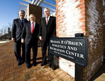 Michael P. O’Brien ’68 (far right), St. Mary’s College of Maryland (SMCM) board member, friend, and donor, stands with Larry Vote (far left), acting president of St. Mary’s College of Maryland (SMCM), and Jim Muldoon, chair of the SMCM Board of Trustees, in front of the new Michael P. O’Brien Athletics and Recreation Center. The athletics center at the college was recently re-named as a tribute to contributions O’Brien made to the college in both the artistic and athletic fields. (Photo: Frank Marquart)