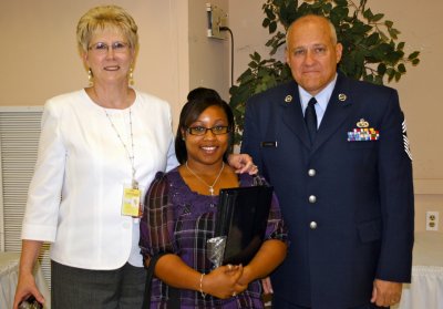 Bria Page, center, receives congratulations from her Cooperative Education teacher Pamela Lightfoot, left, and her supervisor Chief Master Sgt. Ronald Sizemore, right, of the National Guard Bureau at Andrews Air Force Base. (Submitted photo)