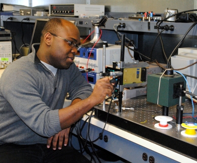 Mark Dandin, 28, a doctoral student who moved to Maryland from Haiti more than a decade ago, performs research in the Integrated Biomorphic Information Systems Lab at the University of Maryland, College Park. (Capital News Service photo by Steve Kilar)