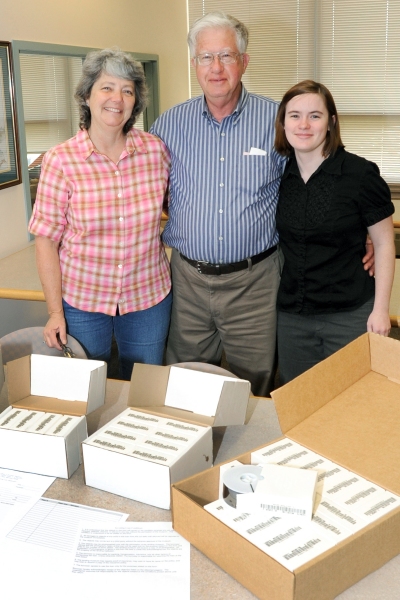 Danny Fluhart, center, of the Dr. Samuel A. Mudd Society, at the urging of Vice President of the Historical Society of Charles County Mary Pat Berry, left, has loaned 34 reels of microfilm of "Mudd and Related Families" to CSM's Southern Maryland Studies Center, here with SMSC Coordinator Amy Richmond, right. (Submitted photo)