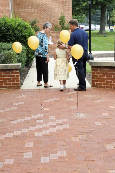 Family members of the late Holli Hempel White, from left, her mother Toni Morse, daughter, Rebecca White and husband Richard White, depart the CSM Memorial and Honorary Bricklaying Ceremony held at the La Plata Campus in September after viewing the brick placed in her memory. (Submitted photo)