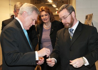 Dr. John Wilkinson, team lead for the research and development effort to counter homemade explosives, shows Secretary of the Navy Ray Mabus how to use the Bulk Homemade Explosives (HME) Detection Kit. (U.S. Navy Photo by Matt Poynor)