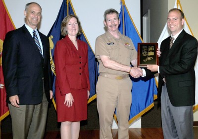 Naval Surface Warfare Center Dahlgren Division (NSWCDD) Technical Director Carl Siel, Office of Naval Research Counsel Catherine Donovan, and NSWCDD Commander Capt. Michael Smith present the NSWCDD Patent Award to Engagement Systems Department engineer Vincent Vendetti for his invention, "The Dovetail Alignment and Locking System" at the command's first Patent Awards Ceremony held in May 2012. U.S. Navy photo by Kimberly Brandts (released).