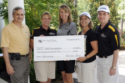 Old Line Bank Executive Vice President Christine Rush, second from left, presents a $10,000 check to CSM Student Life and Athletics Director Michelle Ruble, center, and CSM Vice President of Advancement Michelle Goodwin at the CSM Foundation Golf Classic at Swan Point Yacht and Country Club on Aug. 16. They are joined by CSM President Dr. Brad Gottfried, left, and CSM Foundation Chair Jay Lilly, right.