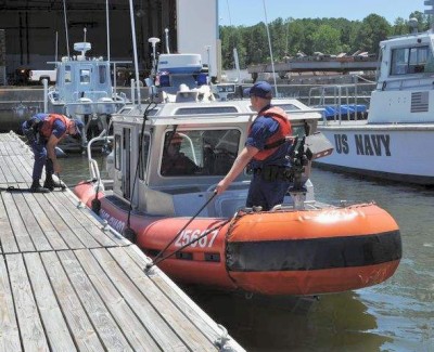 Coast Guard Machinery Technicians 1st Class Matt K Thrappas tie up a response boat at the West Basin Marina on NAS Patuxent River while Coast Guard Boatswain's Mate 1st Class Thomas Smith keeps it steady. U. S. Coast Guard Station St. Inigoes missions include search and rescue support to Pax River and its tenant test and evaluation facilities, presidential security operations and liquid natural gas tanker protection. (Photo: Shannon Slaughter, NAWCAD)
