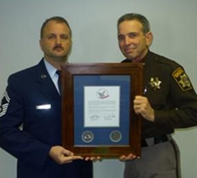 Cpl. Charles Gass presents award to Sheriff Rex Coffey. (Submitted photo)