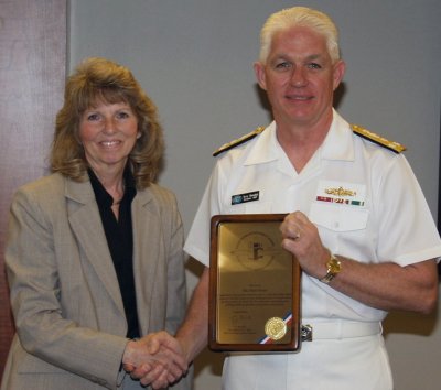 DAHLGREN, Va. - Navy Strategic Systems Programs (SSP) Director Vice Adm. Terry Benedict presents a plaque to Patricia Fetter - a Naval Surface Warfare Center Dahlgren Division (NSWCDD) principal scientist - as he honors her with the SSP Director's award at a ceremony. Benedict described Fetter's achievements as pivotal to the success of the Fleet Ballistic Missile Strategic Weapons System program and fundamental to providing credible and affordable sea-based deterrent missile systems. Fetter's name is also inscribed on an SSP headquarters "living plaque" displaying the chronology of the award.