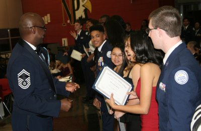 Senior Master Sgt. Kevin Hartfield, an Air Force ROTC instructor at North Point High School, presents certificates of achievement to North Point seniors at the Charles County Public Schools eighth annual Joint Service Military Ball held Dec. 5 at North Point. The annual event highlights students enrolled in the Junior Reserve Officers Training Corp (JROTC) program.