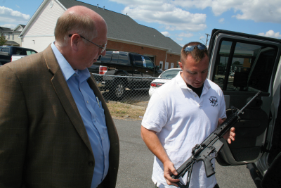 St. Mary’s Dep. Mike Worrey, right, talks to La Plata Police Chief Carl Schinner about the finer points of one of two custom built AR-15 rifles Worrey built for patrol rifle use by Schinner’s officers. Worrey operates Legion Rifles based in Mechanicsville. (Photo: St. Mary's County Times)
