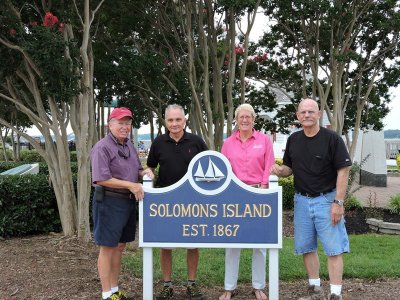 (Pictured left to right) Jim Shepherd, Jim Langley, Melissa McCormick, and Skip Edwards stand behind the newly installed Solomons Island sign. (Photo courtesy Robert Hurry)