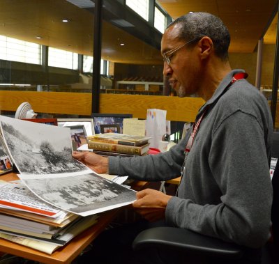 Chris Haley, director of the study of the legacy of slavery in Maryland at the Maryland State Archives, reviews pictures of a staff member's ancestors, one of whom is pictured with his manumission, the certificate of freedom during the time of slavery. (Photo: Brittany Britto)