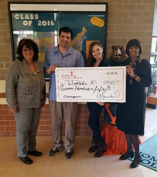 Charles County Arts Alliance Board Member Vicki Marckel (third from left) presents the check for $750 to Westlake High School representatives (from left) Marie Westhall, James Mascia and Ruth Carter.