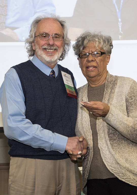 Following a standing ovation given by faculty and staff, Paul Toscano, left, is congratulated and given his 35-year pin by CSM Board Chair Dorothea Smith at the Feb. 26 Service Recognition Ceremony held at the La Plata Campus.