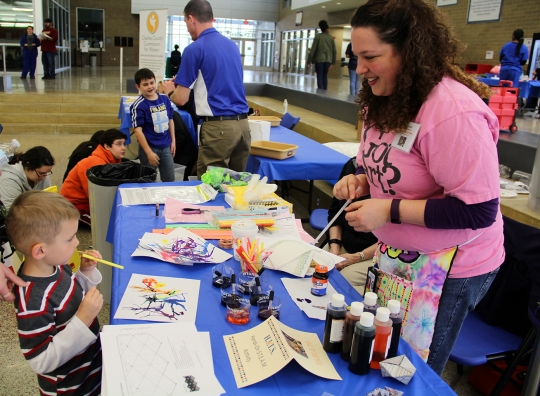Piccowaxen Middle School art teacher Gayle Kraus, right, works with Maddox Yates, a prekindergarten student who attends Archbishop Neal School, on a Hands-On S.T.E.A.M. Activity at the first Charles County Public Schools History, Industry, Technology and Science Expo held March 19 at St. Charles High School. The Expo replaces the annual Science and History Fairs and also showcased several school system programs available for students. These programs include robotics, the Code.org computer science partnership and offerings, Project Lead the Way, the Teacher Academy of Maryland (TAM), interactive media production and more.