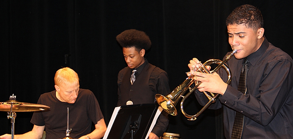 Professional drummer Gregg Bissonette, left, led a workshop for high school jazz bands during Jazz Fest at the College of Southern Maryland earlier this month. Maurice J. McDonough High School freshman Jonathan West listens as Daniel Campos, a senior and trumpet player, performs a solo. (submitted photo)