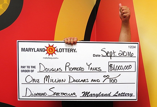 Douglas Romero Yanes gave a thumbs-up after claiming a $1 million top prize on the Diamond Spectacular scratch-off. (Photo courtesy of Md. Lottery)