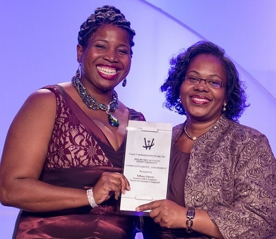 DETROIT, Mich. -- Navy engineer Tiffany Owens, left, receives the Women of Color Magazine's 2016 Community Service Award at the magazine's annual awards gala held at the Detroit Marriott in the Renaissance Center, Oct. 15. Owens was honored for inspiring and mentoring students throughout Virginia in a myriad of science, technology, engineering and mathematics programs. "In serving our country as a systems safety engineer at the Naval Surface Warfare Center Dahlgren Division, Tiffany Owens has also gone above and beyond in service to her community," said Karen Davis, Naval Sea Systems Command Executive Director for Surface Warfare, told the audience before presenting the award to Owens.