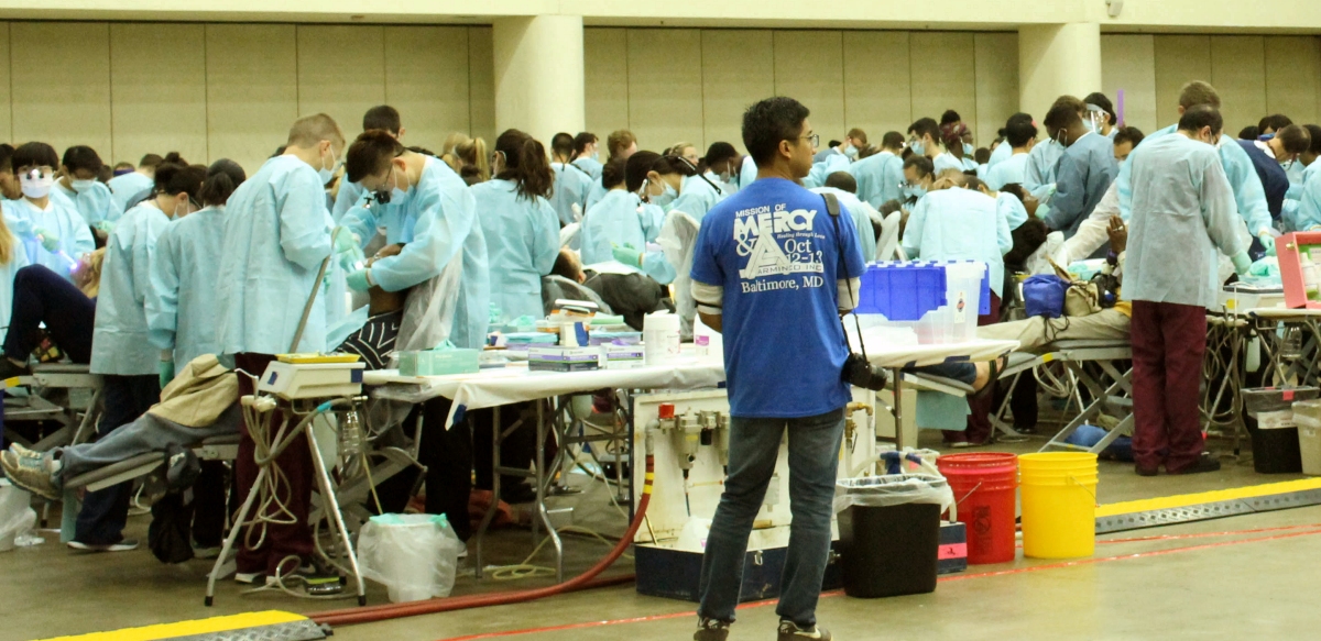 University of Maryland, School of Dentistry students attend to hundreds of people in need of dental service at a Remote Area Medical Clinic, in Baltimore, Md., Oct. 11, 2017. (Photo: Oluwatomike Adeboyejo)