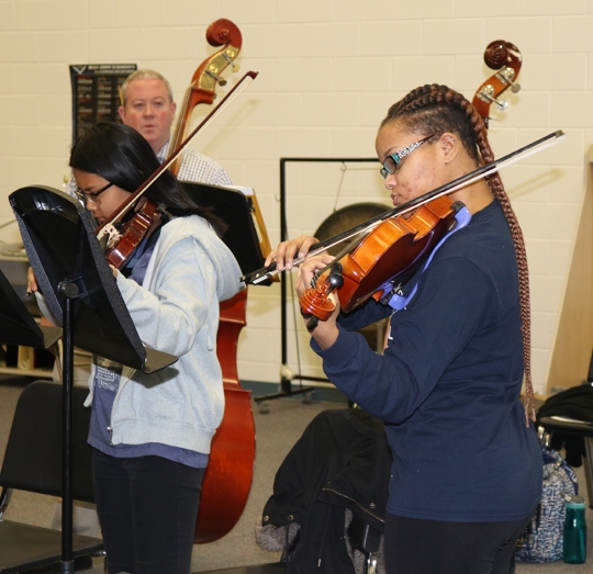Henry E. Lackey High School junior Suan Hill, right, practices on her viola with the school orchestra during a Jan. 10 strings clinic held at the school. Dr. Alan Freeman, director of instrumental music at Lackey, coordinated the clinic for his students and invited three professional musicians to work with them. The clinic was supported through funding from a $500 Charles County Arts Alliance grant and the band boosters.
