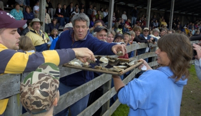 Angela Leeth, a finalist in the 2006 National Oyster Shucking Contest, shares the spoils of her efforts with lucky members of the audience.