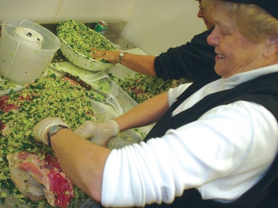 Aggie Tinsley, of McKay’s Fine Food and Pharmacy stuffs one of a planned 400 stuffed hams to be available in McKay’s food stores for Thanksgiving. (Photo by Guy Leonard, County Times)