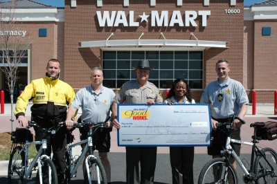 Laurie Bennett, manager for the Wal-Mart in Dunkirk presents a ceremonial $1000 check to Calvert Sheriff Evans to help support youth bicycle programs. Pictured from left to right: Dep. Nicholas DeFelice, F/Sgt. William Soper, Sheriff Mike Evans, Laurie Bennett, Sgt. Timothy Fridman. (Photo courtesy CCSO)