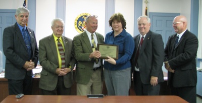 Lisa Bachmann, a County employee, receives the County's 2008 Distinguished Employee of the Year award from the Board of Commissioners on Tuesday in their meeting room in Leonardtown. (Photo courtesy SMC Gov.)