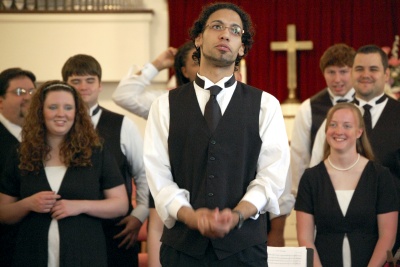 CSM student Andrew Dias III shares the inspiration of his composition, “Ave Verum Corpus,” just before directing CSM Chamber Singers, including rear from left Jimmie Bise Jr., Emily Powers, Bryant Dennison, Louis Gramby, Nico Maldonado, John Gardiner and Cynthia Kirscht.