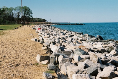 Rip Rap rocks line the shoreline at Point Lookout in St. Mary's County to prevent beach erosion. The U.S. Environmental Protection Agency estimates that 80 to 90 percent of the sandy beaches along America's coastlines have been eroding for decades. Individual beaches may lose only a few inches per year; others may lose much more. Of particular concern is the effect climate change, which causes sea level rises and also increases the severity and frequency of harsh storms, has on beach erosion. (Photo: David Noss)