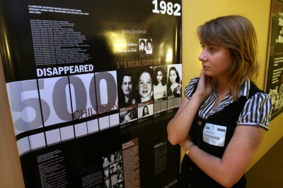 St. Mary's College of Maryland student Olivia Williams ('09) of McClellanville, S.C., reads the names of some of the 500 children abducted in Argentina from 1976 to 1983 at an event organized by the Argentine Embassy in Washington, where SMCM students learned about the Grandmothers of Plaza de Mayo, an organization working to return children who disappeared during the country's military dictatorship to their families. (Submitted photo)