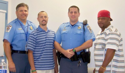 Sheriff Tim Cameron, Jason Brown, Deputy Thomas Seyfried, and Jeramiah Cooper. Brown and Cooper were commended for apprehending a shoplifting suspect. (Submitted photo)