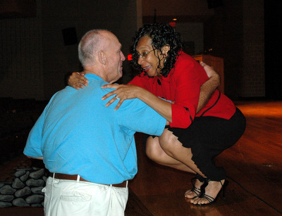 Albie Norris, left, hugs Joan Groves Briscoe. The two had not seen each other since graduating from Great Mills High School in 1959. (Submitted photo)