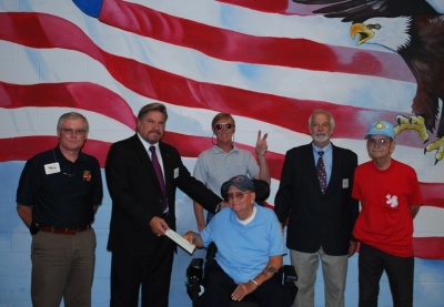 (Standing left to right) Michael Far, Deputy Director for Charlotte Hall Veterans Home; Robert Hall, Governor Patuxent Moose Lodge Hollywood; Timothy O'Connor; Ron Payne and Kermit Zerby. Receiving the donation is resident Francis Kellum (seated).
