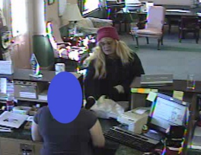Robbery suspect photographed at teller's window by bank security cameras.