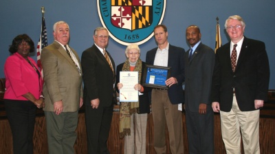 (Left to Right) Commissioner Vice President Edith J. Patterson, Commissioner Samuel N. Graves, Jr., Commissioner President Wayne Cooper, Norma Favier (Mother of Paul Bales), Paul Bales, owner of The Crossing at Casey Jones Restaurant, Commissioner Reuben B. Collins, II, and Commissioner Gary V. Hodge pose following the naming of Paul and Lisa Bales, owners of The Crossing at Casey Jones Restaurant in La Plata “Soar Like an Eagle Entrepreneur of the Month” for January 2009.