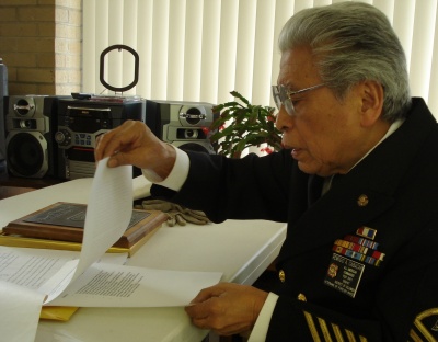 Remigio Cabacar, sitting in his Fort Washington barbershop, is one of an estimated 3,000 living Filipino Americans who fought with U.S. troops against the Japanese in World War II. (Photo: Leonard Sparks, CNS)