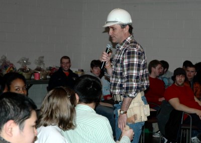 Rich Edgar, SMCM director of admissions, describes the next item up for auction, a SMCM diploma frame, to students at the 15th Annual Christmas in April Auction at St. Mary’s College of Maryland. Participants bid on gift baskets, college memorabilia, and many other items donated by local sponsors, to raise money to fund the rebuilding of homes for low-income homeowners in St. Mary’s County. (Submitted photo)