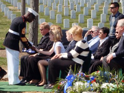 Gunnery Sgt. William J. Dixon, the Marine Corps funeral director, comforts the family of former Marine Sgt. Michael Isky during Isky's funeral, March 19. (Photo: Jennifer Hlad)