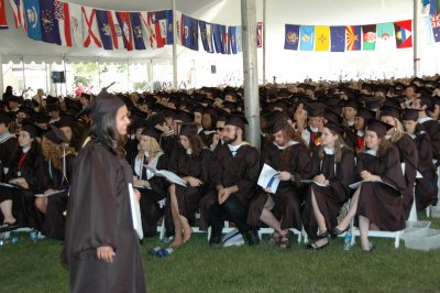 Mariel Sylvia Saez, of Leonardtown, stands with her bachelor of arts in economics degree while fellow graduates look on. Saez graduated magna cum laude. On May 15, 440 seniors graduated from St. Mary’s College of Maryland including 39 students from St. Mary’s County. (Submitted photo)