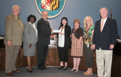 Stacy Crowe (center holding check), past president of the Waldorf Jaycees, presents a $10,000 to the Commissioners of Charles County to benefit Aging and Senior Programs. (Submitted photo)