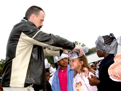 Pictured left is Joseph McMahan, a first-grade teacher at Dr. Gustavus Brown, as he helps student Selah Calacan, pictured right, put on her birthday hat. (Submitted photo)