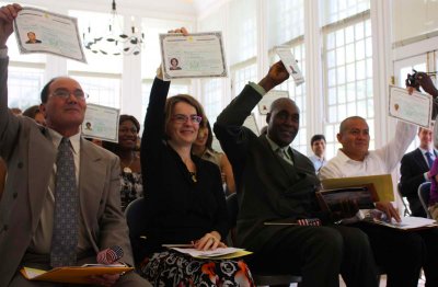 Salah El Machi, from Morocco, Francesca Boffi, from Italy, and Carlton Willesley Brown, from Jamaica (from left) receive their naturalization certificates in a ceremony Sept. 20 at the Hampton National Historic Site in Towson, Md. (Photo by Maryland Newsline's Ilana Yergin)
