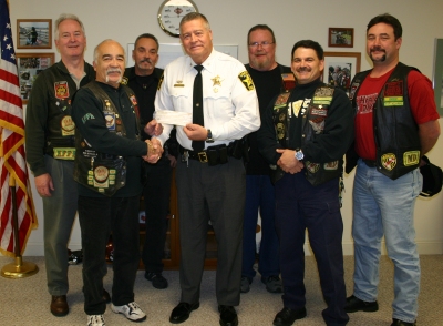 (Front row left to right) R.J. "Bomber" Nieves, President, Sheriff Mike Evans, R. "Rocky" Roccipiore, Vice President, and R. "Beef" Starling, Asst. Sgt. at Arms. (Second row left to right) M. "Stitch" Murphy, Treasurer, B. "BD" Durner, Road Captain, and S. "Spatz" Logan, Secretary.