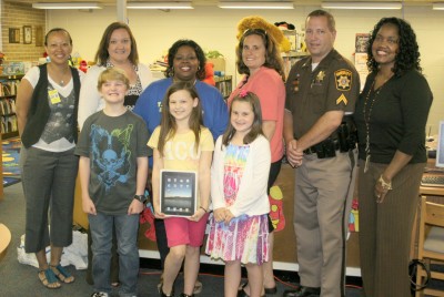 Students at T.C. Martin Elementary School were recently named winners in the MAC Recycling poster contest. Representatives visited the school last month to present gift cards and other prizes to the winners. Pictured, back row from left, are: Tracey Jarmon, school counselor; Caroline Timmons, Martin vice principal; Sabrina Robinson-Taylor, Martin principal; Carey Wargo, school funding coordinator and site locator for MAC Recycling; Officer Donald Kabala; and Melody Philpotts, library/media specialist at Martin. Pictured, back row from left, are: Martin students Luke Starks, Madison Lucas and Carly Carter. (Submitted photo)
