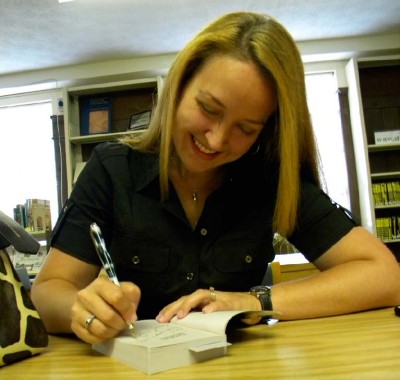 Kendra Leigh Castle, of Leonardtown, signs a copy of “Dark Awakening.” (Photo: Sarah Miller)