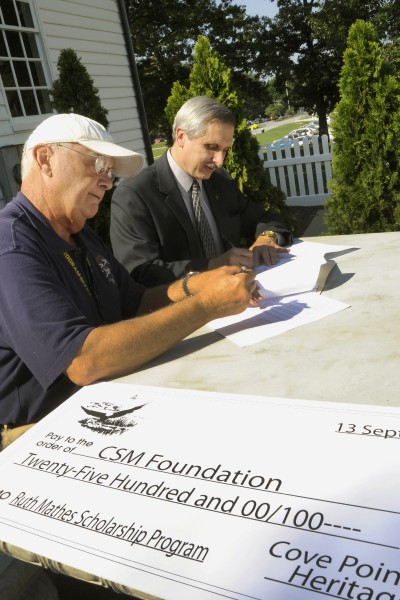 College of Southern Maryland President Dr. Brad Gottfried, right, accepted a check for $2,500 from Cove Point Natural Historic Trust Board of Directors President Michael R. Rudy for the creation of the Ruth Mathes Scholarship for students working toward an associate’s degree in biological or environmental sciences. (Submitted photo)