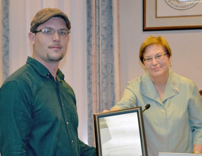 William Kreamer of Chesapeakes Bounty in St. Leonard accepts the Green Grocer of the Year Award from Commissioner Susan Shaw